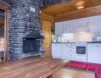 a kitchen with wooden cabinets and a fireplace
